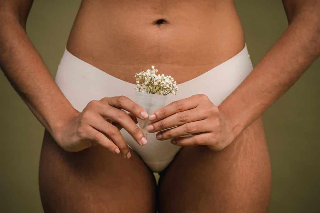 Mulher segurando coletor menstrual
