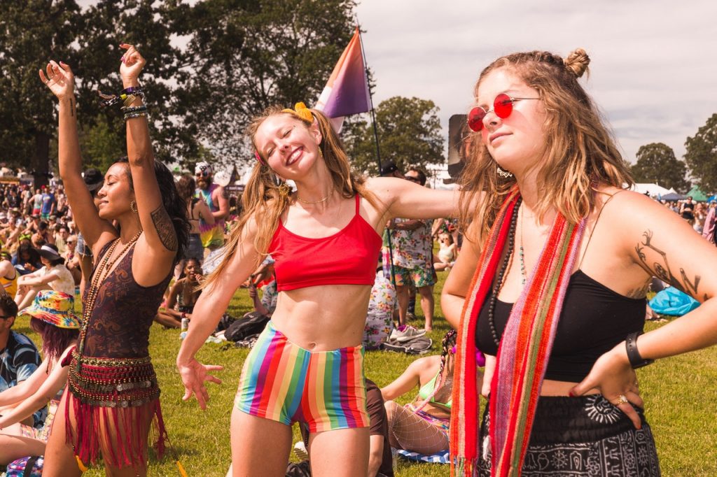 Três mulheres fantasiadas curtindo o Carnaval. 