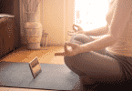 Mulher meditando na sala de estar