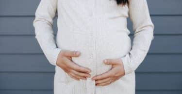 Mulher grávida com suas mãos sobre sua barriga
