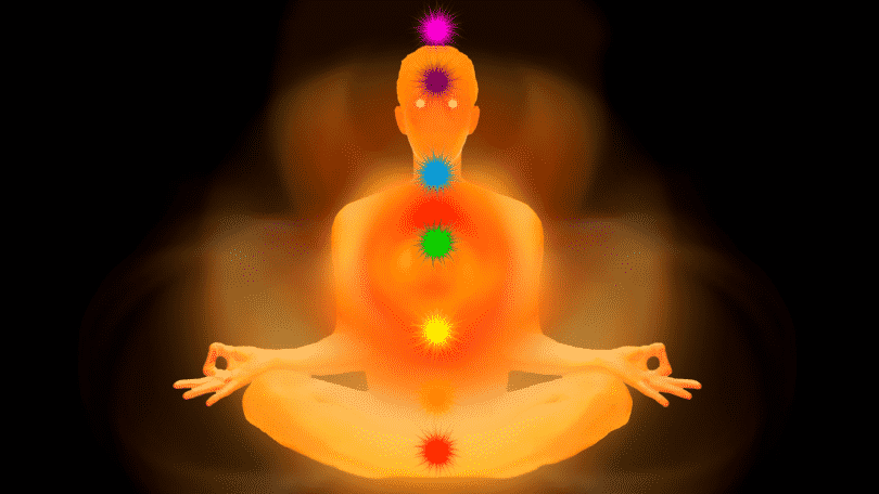 Silhueta de uma pessoa meditando com os sete chakras marcados no corpo, em evidência