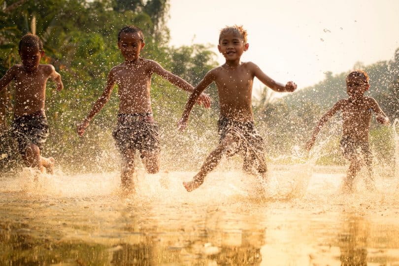 Meninos brincando em um lago.