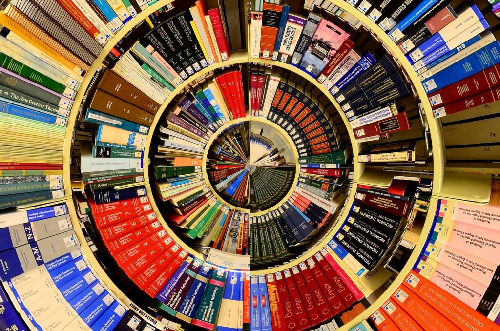 Vários livros reunidos em prateleiras. Imagem distorcida de maneira circular.