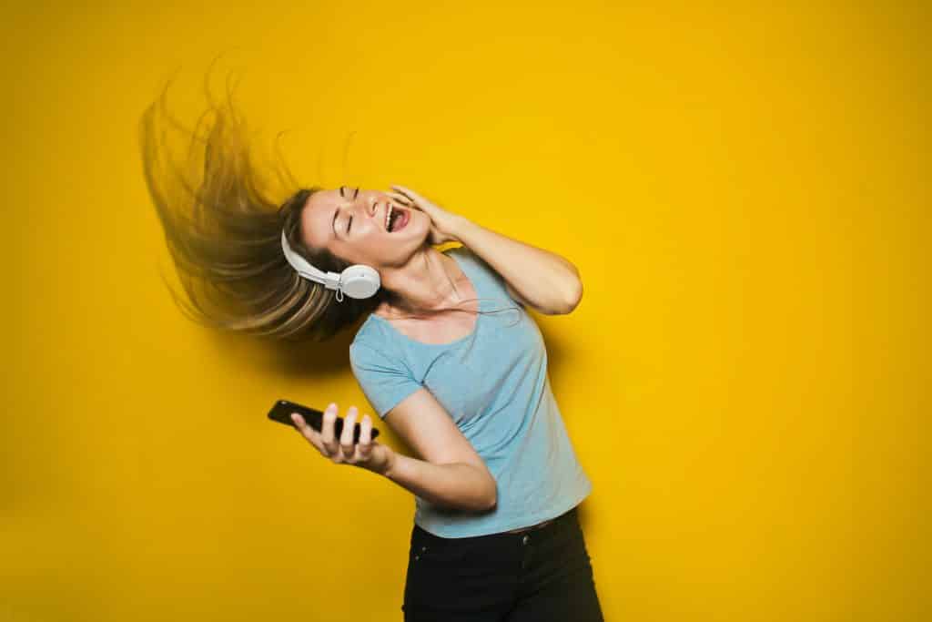 Mulher feliz enquanto ouve música