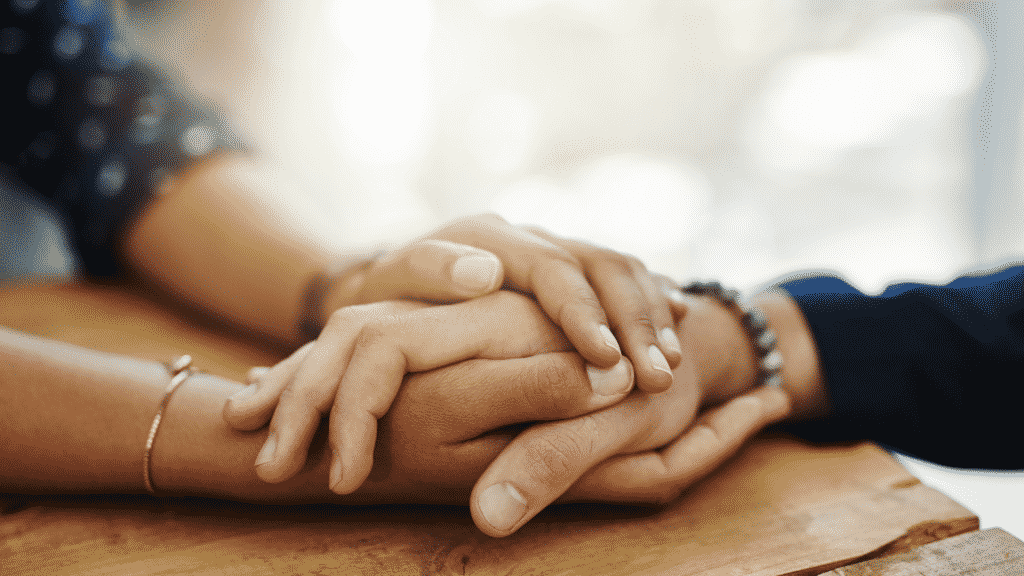 Uma pessoa segurando a mão de outra pessoa