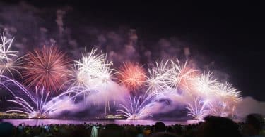 Uma fotografia do réveillon no Rio de Janeiro. Vários fogos de artifício sendo expelidos.