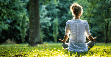 Mulher no parque meditando