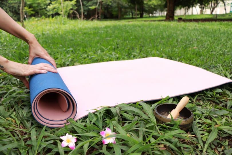 Tapete de Yoga em cima da grama.