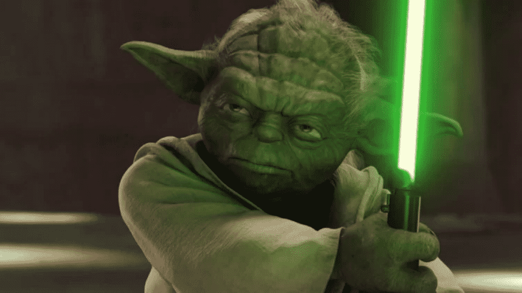 Imagem do mestre Yoda segurando um sabre de luz