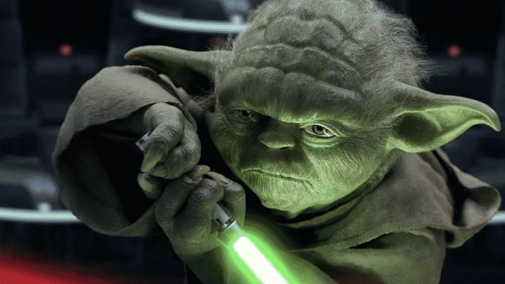 Imagem do mestre Yoda segurando um sabre de luz