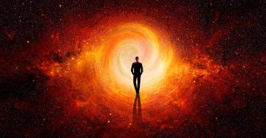 Silhueta de homem na frente de um buraco espiralado laranja, no meio do universo