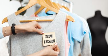 Regata cinza com uma etiqueta escrito "slow fashion"
