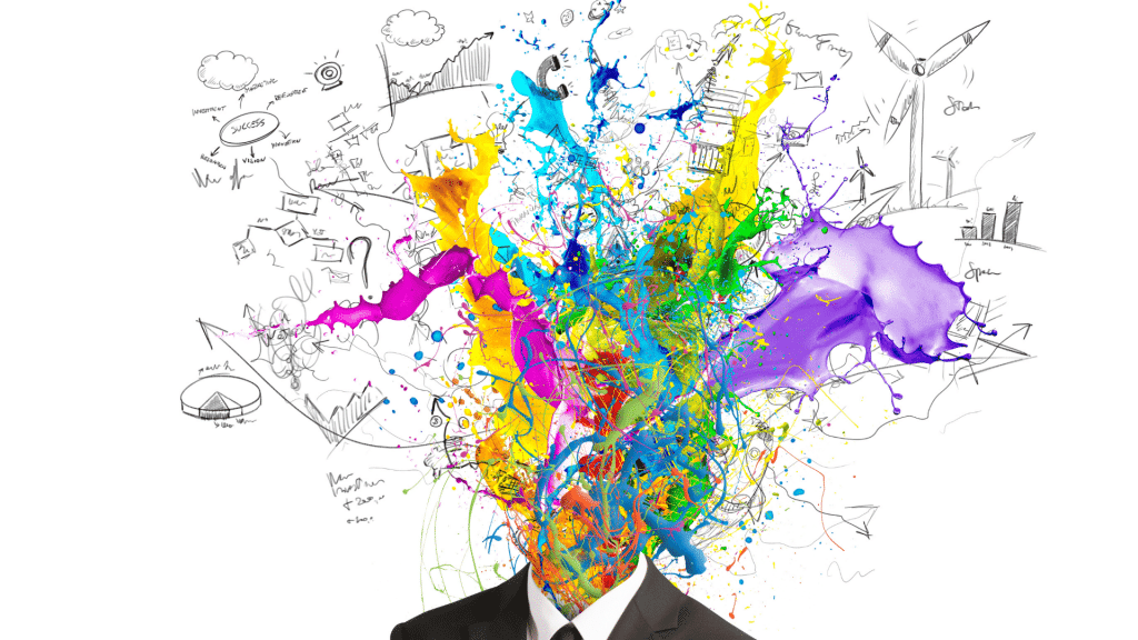 Pessoa usando terno e sua cabeça é uma explosão de tinta e cores espalhada pela imagem com diversas ideias e pensamentos representados