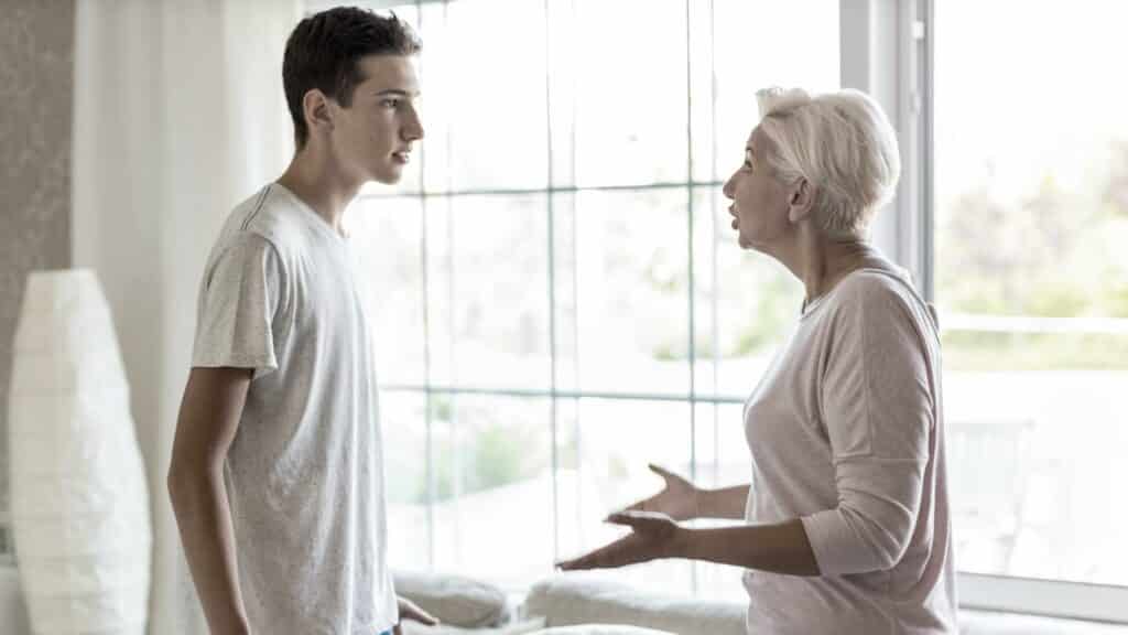 À direita, um homem jovem. À esquerda, uma mulher idosa. Ambos parecem discutir.