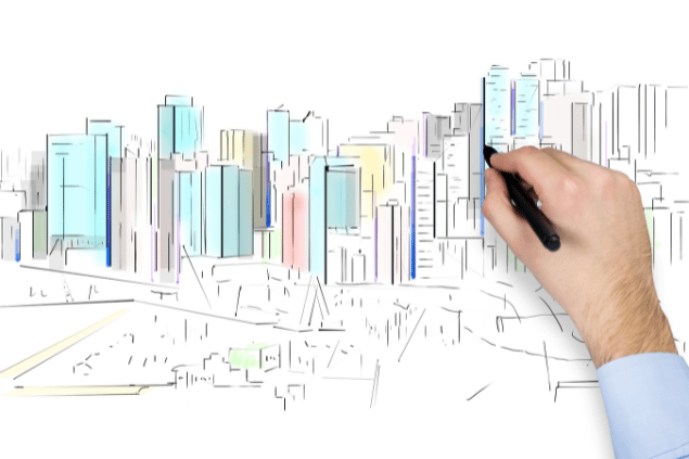 Mão desenhando e pintando uma cidade