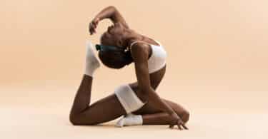 Mulher fazendo uma pose avançada de Yoga
