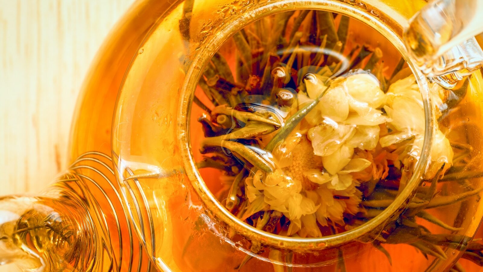 A Glass Tea Pot With Flower Chinese Tea Top Close Up View