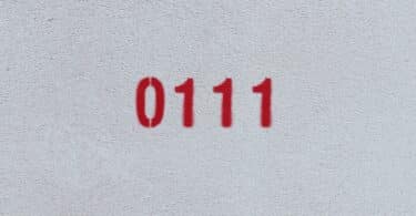 Numeral 0111 escrito em vermelho, em uma parede.