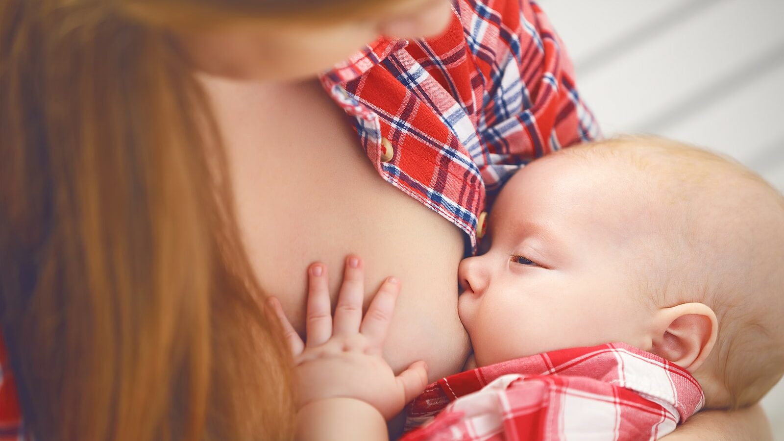 breastfeeding. mother breast feeding her baby toddler