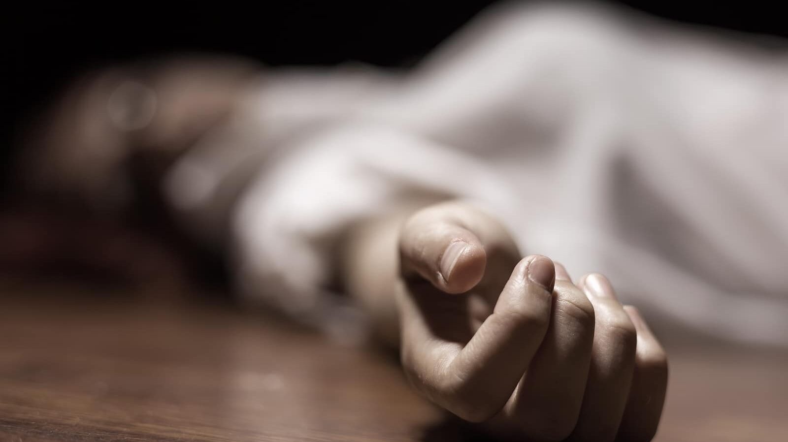 The dead woman's body. Focus on hand ** Note: Shallow depth of field
