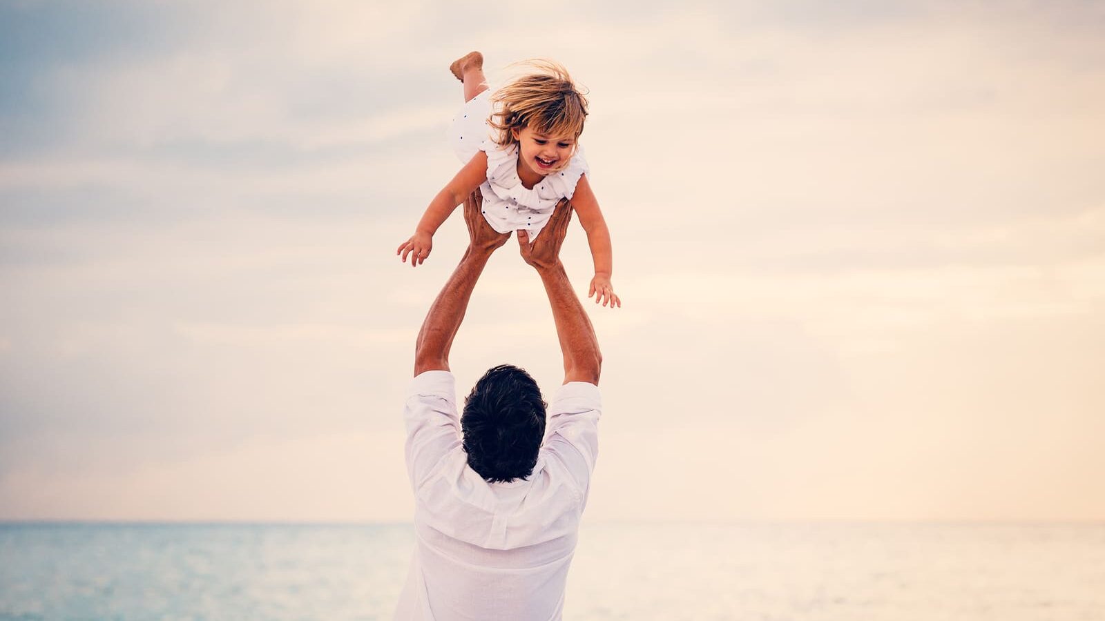 Healthy Father and Daughter Playing Together at the Beach at Sunset. Happy Fun Smiling Lifestyle