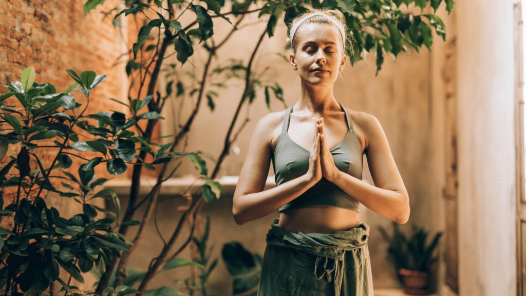 Mulher expressando gratidão em uma pose de yoga. Namastê.