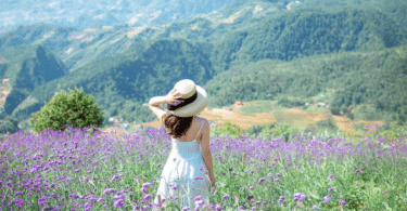 Mulher parada no meio de um campo de flores