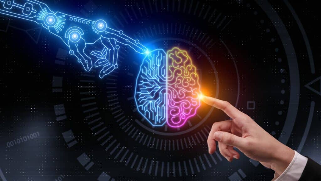 Imagem de uma mão e um cérebro, representando o lado humano e o outro robotizado da IA.
