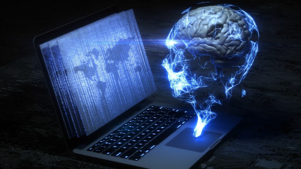 Imagem de um computador e um cérebro conectados, trazendo o conceito de inteligência artificial.