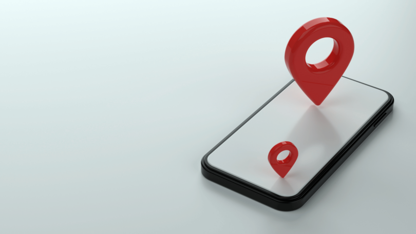 Na imagem, há uma ilustração em 3D de um celular e dois "pins" de localização em cima dele.