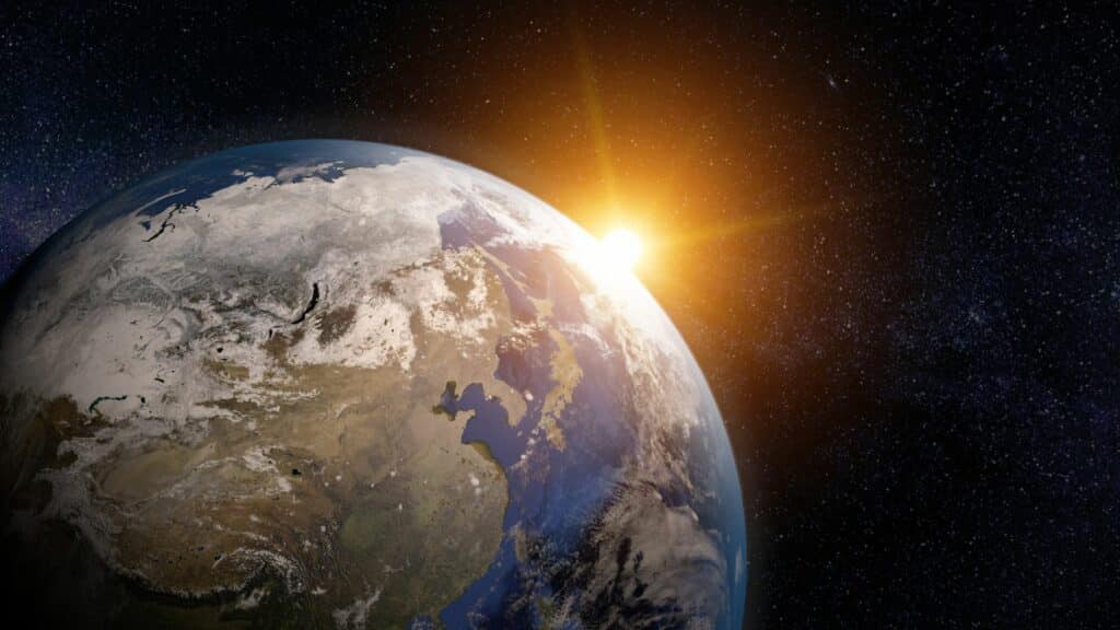 Imagem do planeta terra e ao fundo a luz solar.